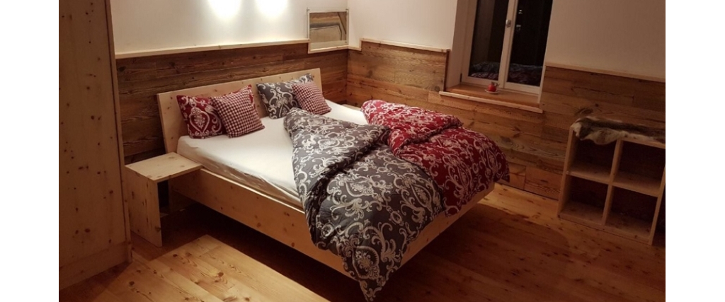 Zirbenschlafzimmer mit Altholzwandverkleidung
